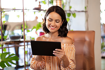 Image showing happy woman with tablet pc at cafe or coffee shop