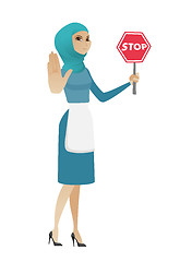 Image showing Young muslim cleaner holding stop road sign.