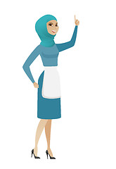 Image showing Young muslim cleaner pointing with her forefinger.