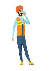 Image showing Young hindu builder talking on a mobile phone.