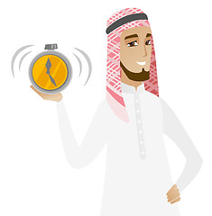 Image showing Muslim businessman holding alarm clock.