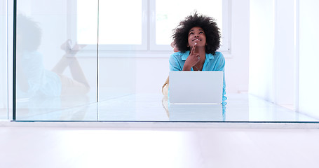 Image showing black women using laptop computer on the floor