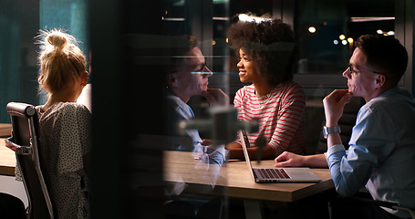 Image showing Multiethnic startup business team in night office