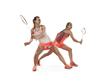 Image showing Young women playing badminton over white background