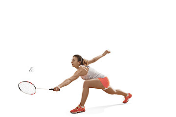 Image showing Young woman playing badminton over white background