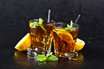 Image showing Two glasses with cold traditional iced tea with lemon, mint leav