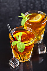 Image showing Two glasses with cold traditional iced tea with lemon, mint leav