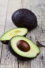 Image showing Fresh organic avocado on old wooden table background. Fresh avoc