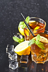 Image showing Two glasses with cold traditional iced tea with lemon, mint leav