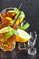 Image showing Two glasses with cold traditional iced tea with lemon, mint leav