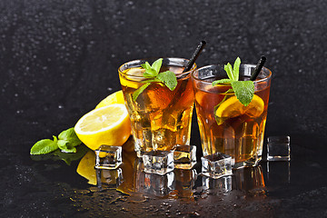 Image showing Two glasses with cold traditional iced tea with lemon, mint leav