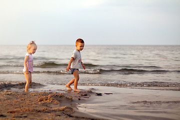 Image showing Happy family brother and sister playing on the beach