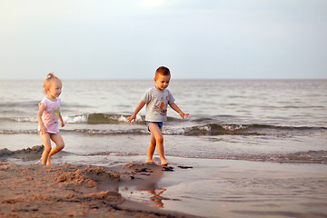 Image showing Happy family brother and sister playing on the beach