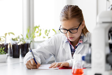 Image showing girl studying chemistry at school laboratory