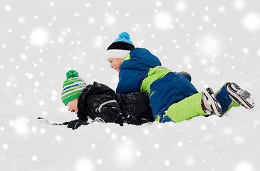 Image showing happy little boys playing outdoors in winter