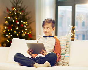 Image showing boy with tablet computer on christmas at home