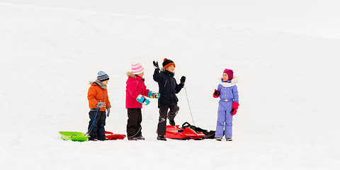 Image showing happy little kids with sleds in winter