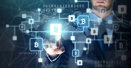 Image showing close up of businessman with bitcoin block chain