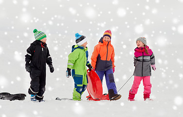 Image showing happy little kids with sleds sledging in winter