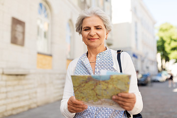 Image showing senior woman or tourist with map on city street
