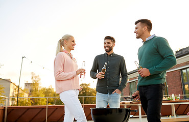 Image showing happy friends having bbq party on rooftop