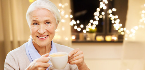 Image showing happy senior woman with cup of coffee on christmas