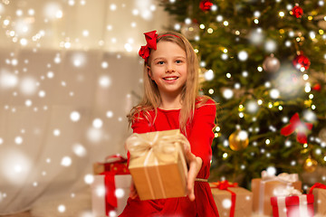 Image showing smiling girl with christmas gift at home