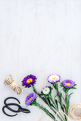 Image showing Bouquet of asters on white wooden background