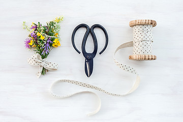 Image showing Bouquet of wildflowers decorated with vintage ribbon