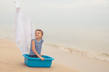 Image showing One happy little boy playing on the beach at the day time.