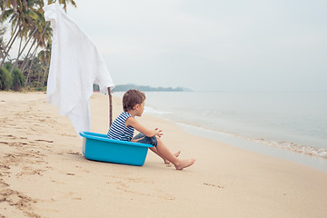 Image showing One happy little boy playing on the beach at the day time.