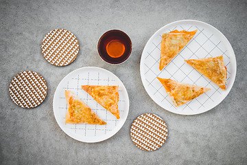 Image showing Cheese pies and cup of tea on concrete background 