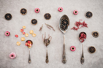 Image showing Herbs, flowers and vintage silver spoons