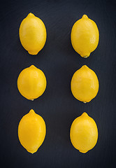 Image showing Six fresh lemons on dark background