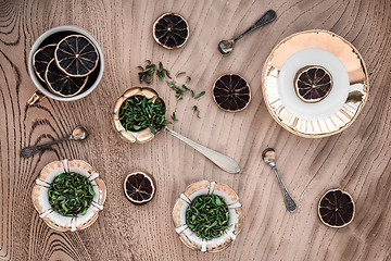 Image showing Green herbs and dried lemon slices