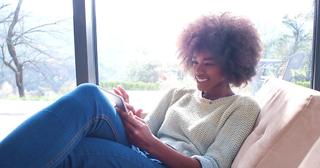 Image showing african american woman at home using digital tablet