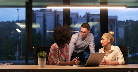 Image showing Multiethnic startup business team in night office