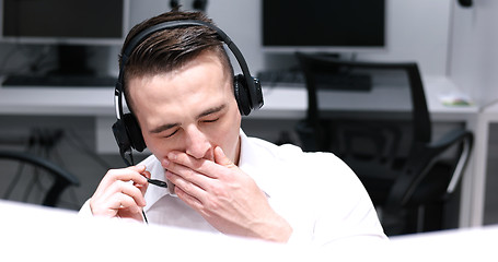 Image showing male call centre operator doing his job