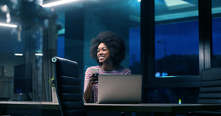 Image showing black businesswoman using a laptop in night startup office