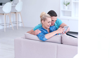 Image showing couple relaxing at  home with tablet computers