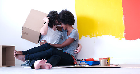 Image showing young multiethnic couple playing with cardboard boxes