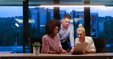 Image showing Multiethnic startup business team in night office