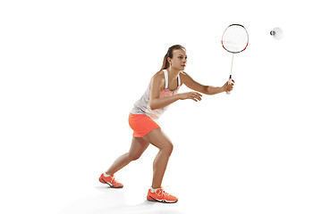 Image showing Young woman playing badminton over white background