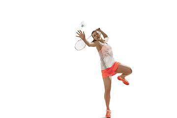 Image showing Young woman playing badminton over white background