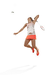 Image showing Young woman playing badminton over white background