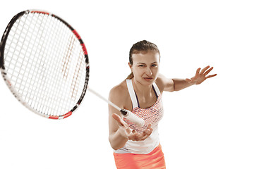 Image showing Young woman playing badminton over white background