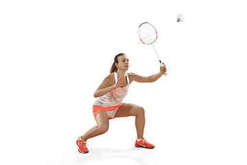 Image showing Young woman playing badminton over white background