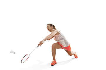 Image showing Young woman playing badminton over white background