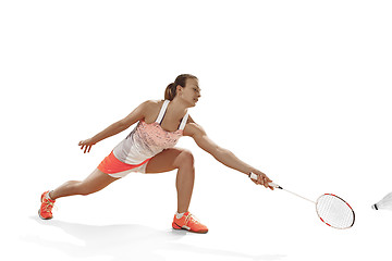 Image showing Young woman playing badminton over white background