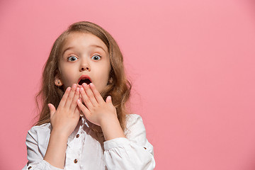 Image showing Beautiful teen girl looking suprised isolated on pink